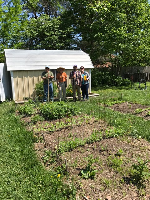 Ann St. Garden volunteers posing next to their shed