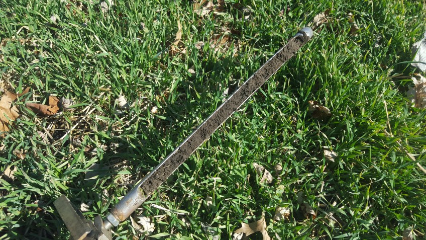 rye and clover cover crop with soil probe showing deep rich soil