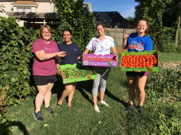 Columbia College students showing garden produce just picked for donation