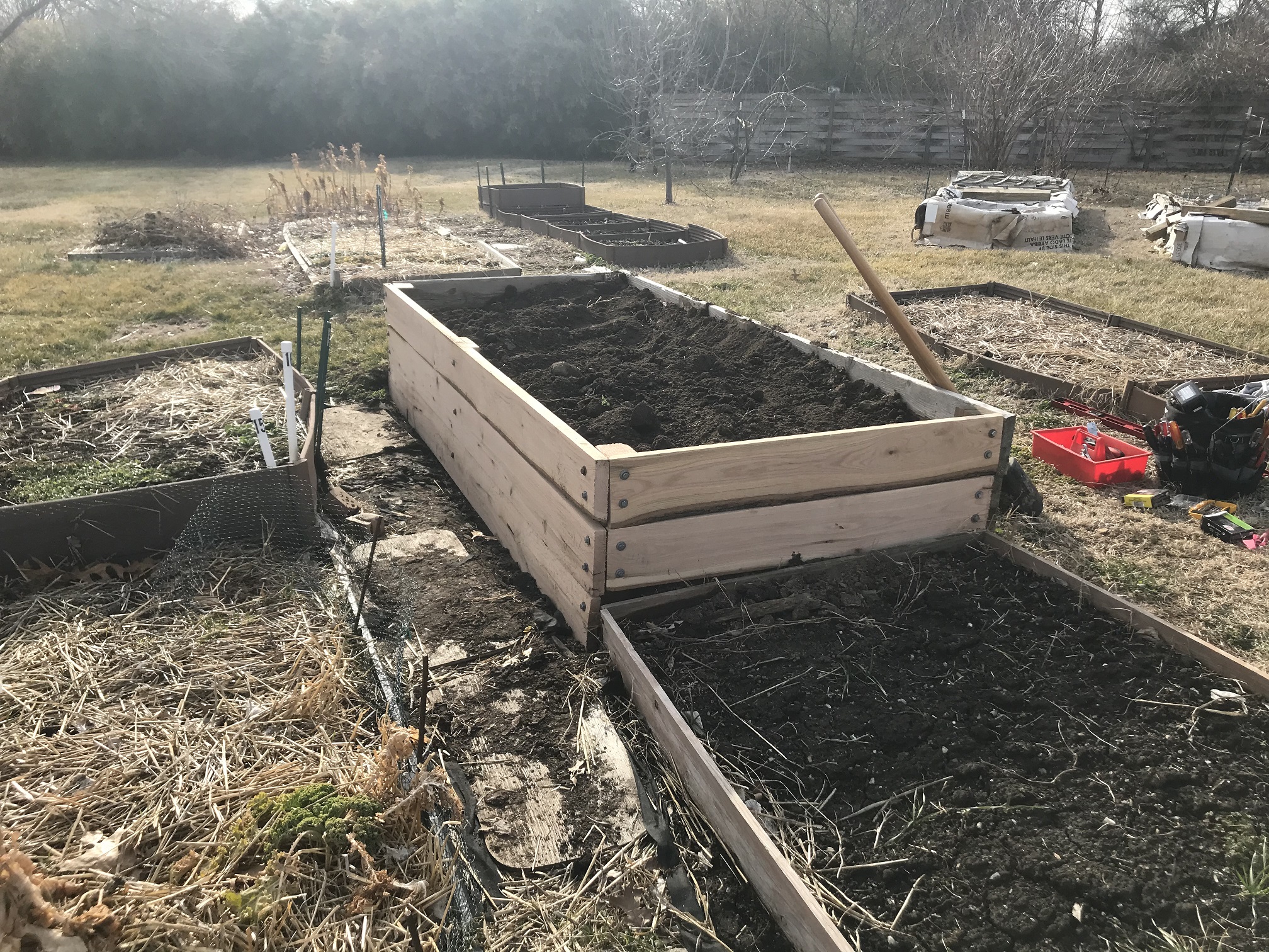 Newly rebuilt raised bed at Unite4Health garden filled with fresh soil and compost