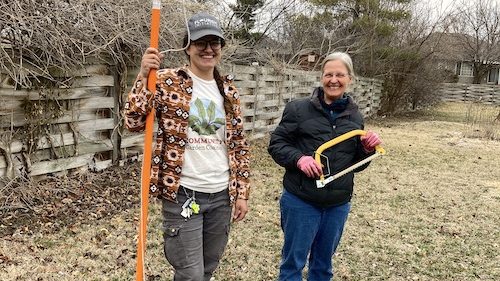 Mallary and Cheryl stand with pruning tools at the Unite4Health garden