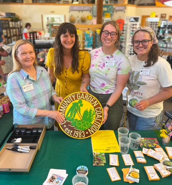 CGC board members and a donor pose with a vintage CGC sign at the Alpine Shop