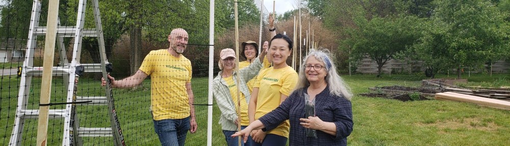 Five ForColumbia volunteers putting up deer fencing at Unite4Health garden